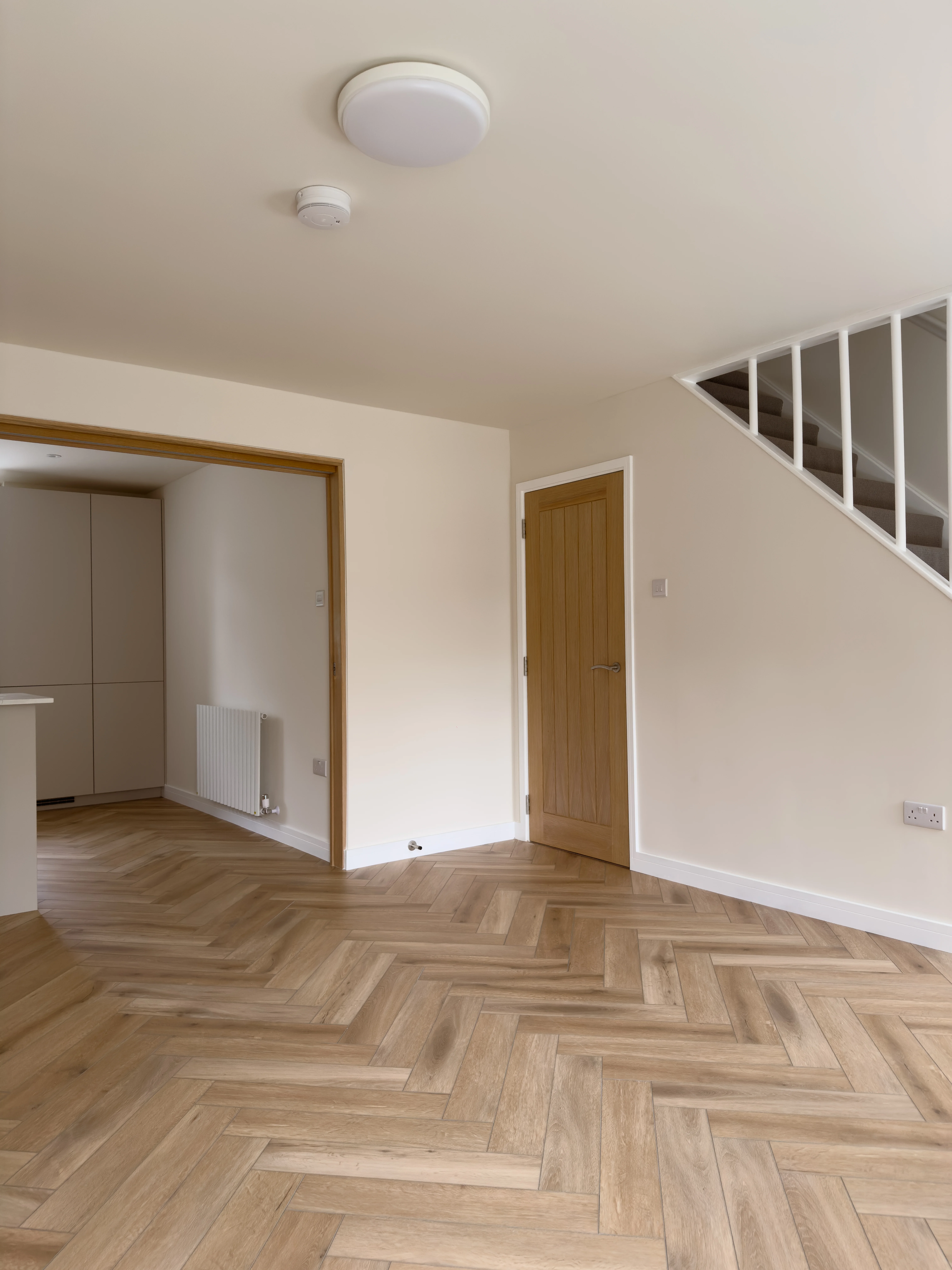 Living room with herringbone flooring, after